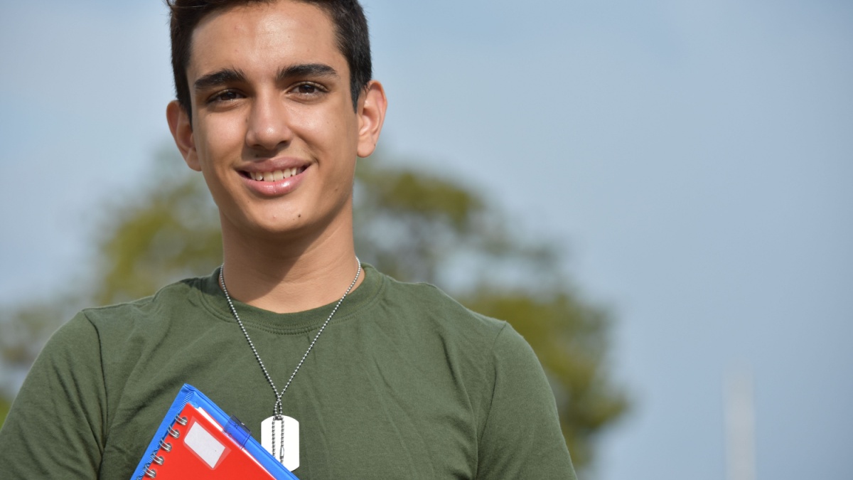 Hispanic Male Teen Military Student And Happiness.