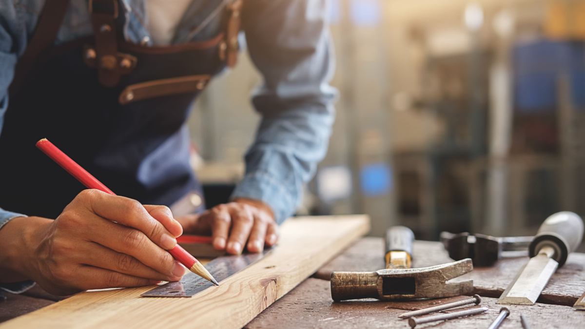 Carpenter working on woodworking machines in carpentry shop. woman works in a carpentry shop.