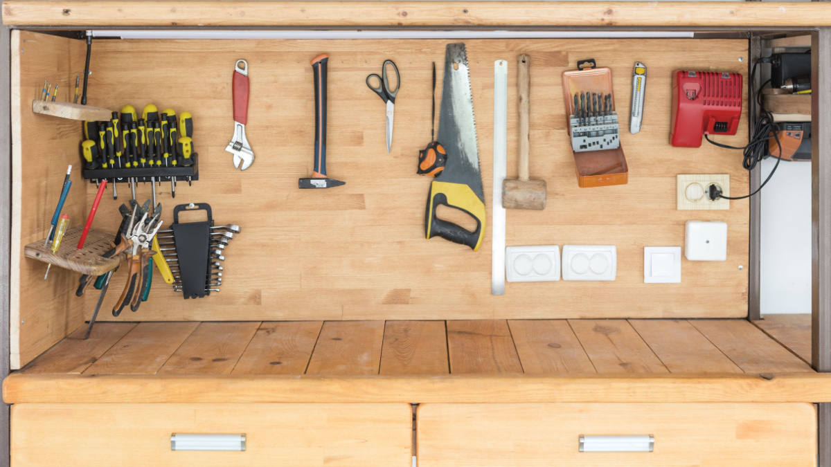 Wooden workbench at workshop. Lot of different tools for diy and repair works. Wood desk for product display.