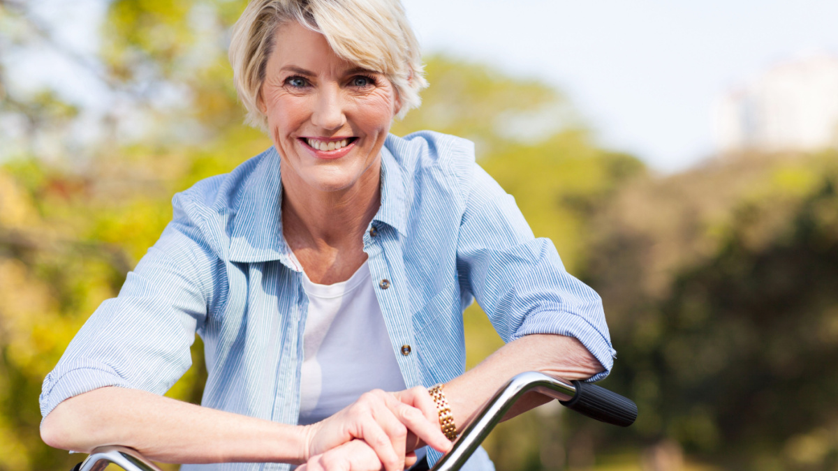 close up portrait of senior woman on a bicycle.
