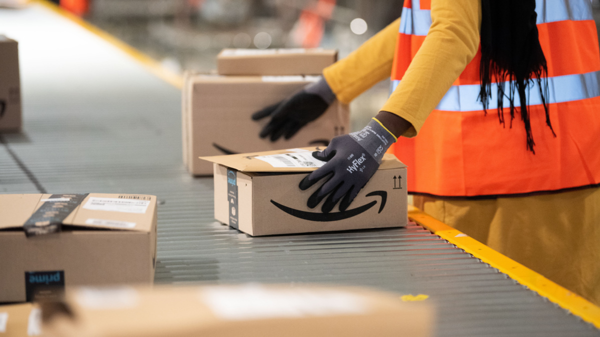 Vélizy, FRANCE Sept. 23th 2019 : Logistics activity on the Amazon site of Vélizy-Villacoublay in France. Packages are sorted by workers on conveyors.