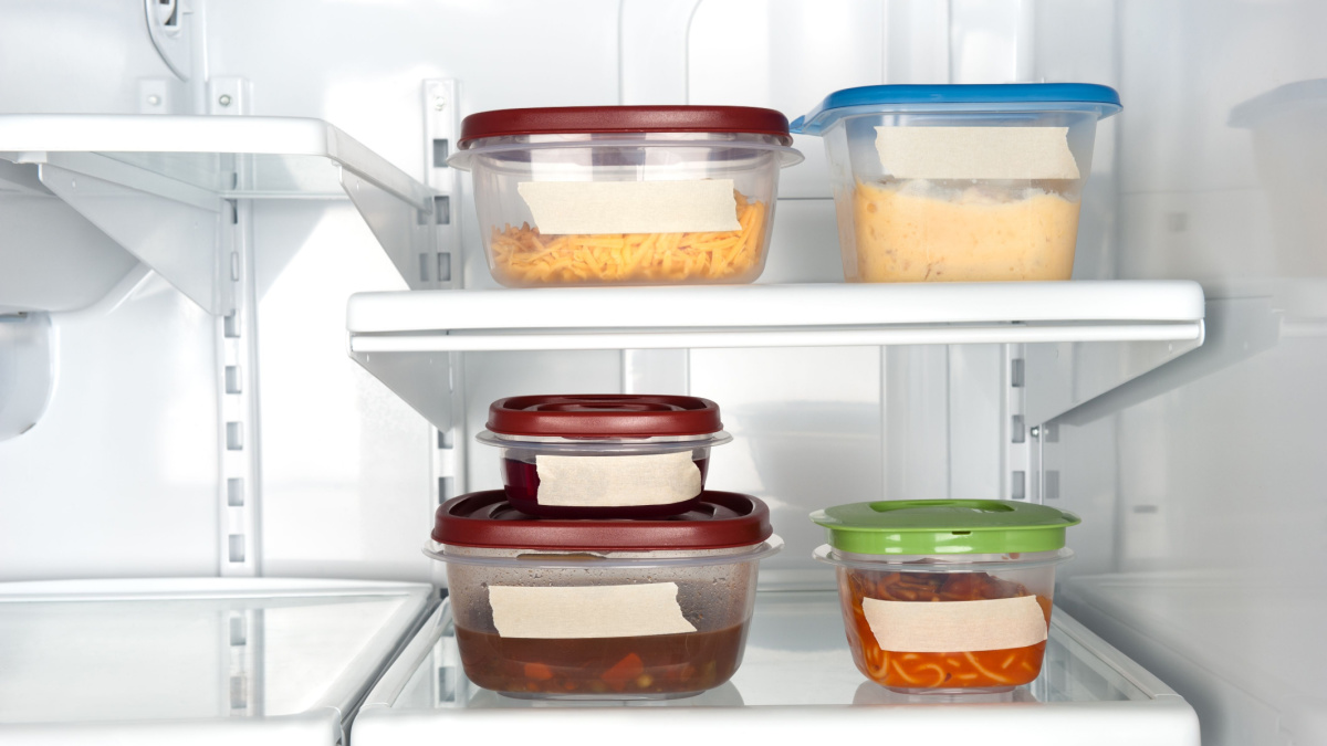 Leftovers in a refrigerator with blank tape for copy.