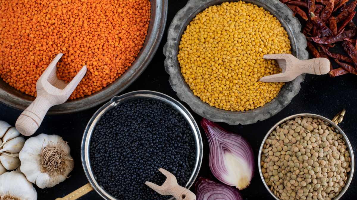 Various of organic lentils on the wooden table. Dried lentils and legumes concept in the bowl.