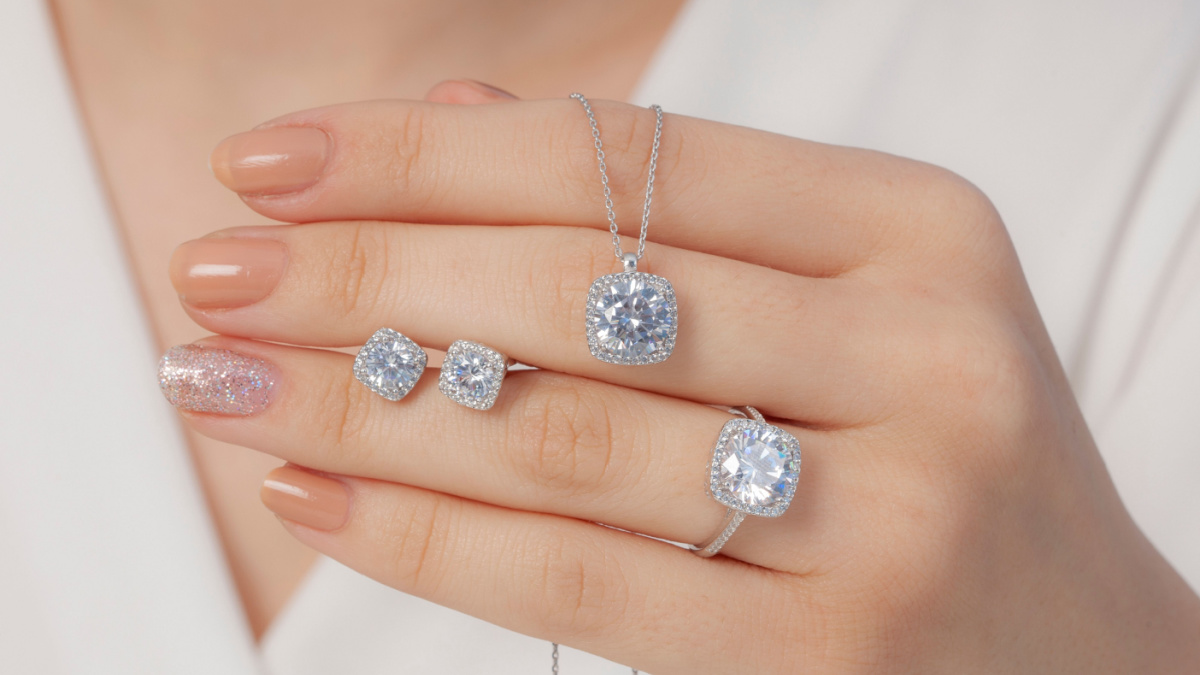 square stone diamond jewelry set in white outfit lady hands.
