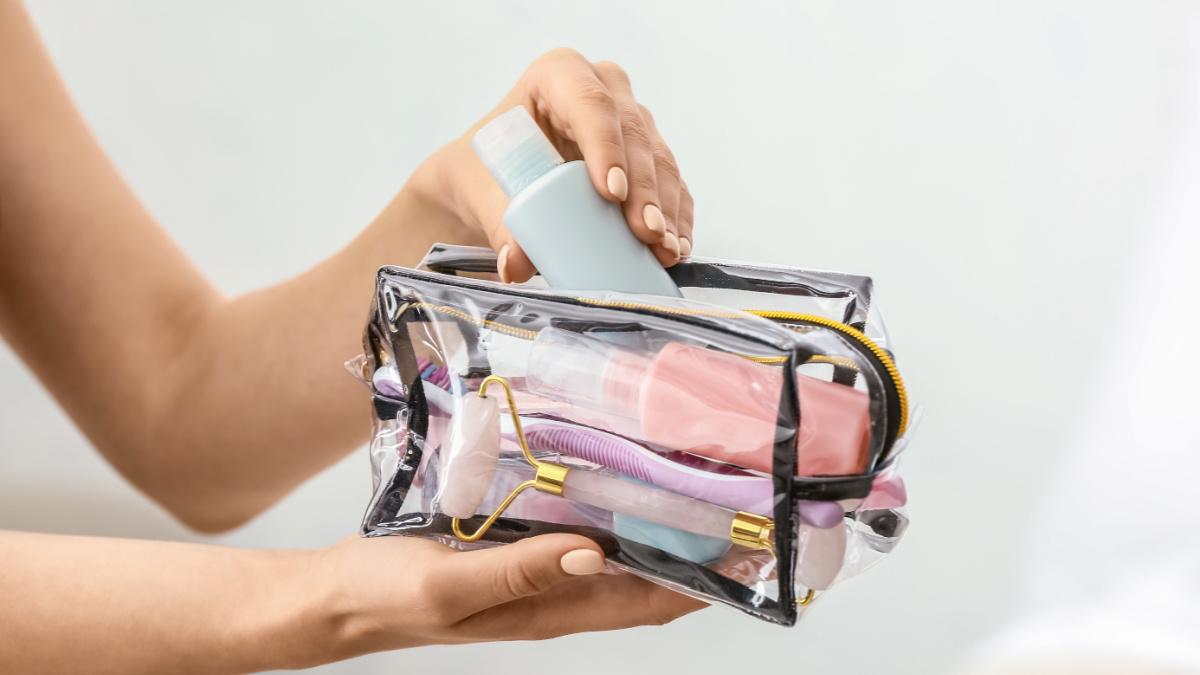 9 Essentials Frugal People Proudly Exclude From Their Shopping List 6 Female hands and cosmetics bag on light background.