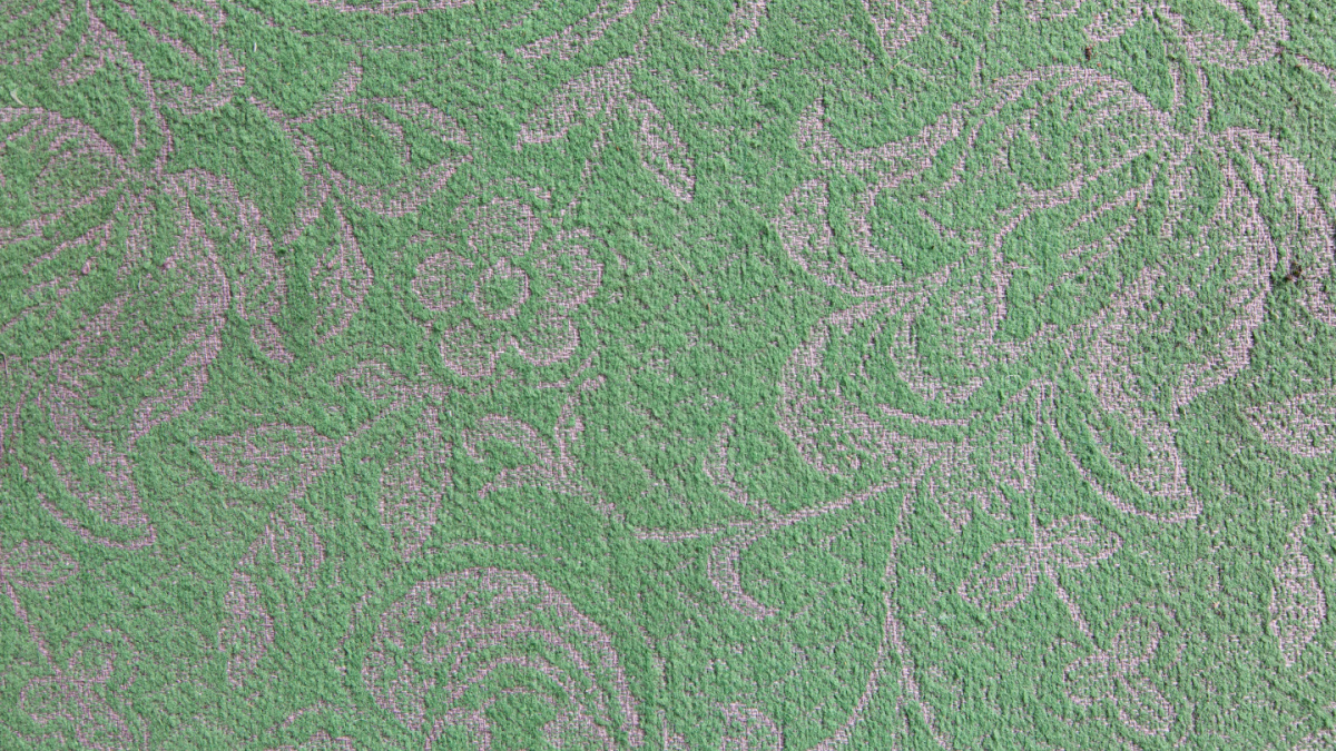 Painted, embossed pattern in green paint on concrete wall. textured background. 80s-90s design. antique finish, wallpaper. Coating from Soviet times. An image of painted flowers.