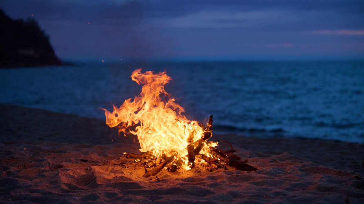 Beach Bonfire selective focus with Beautiful Sunset or sunrise no people.