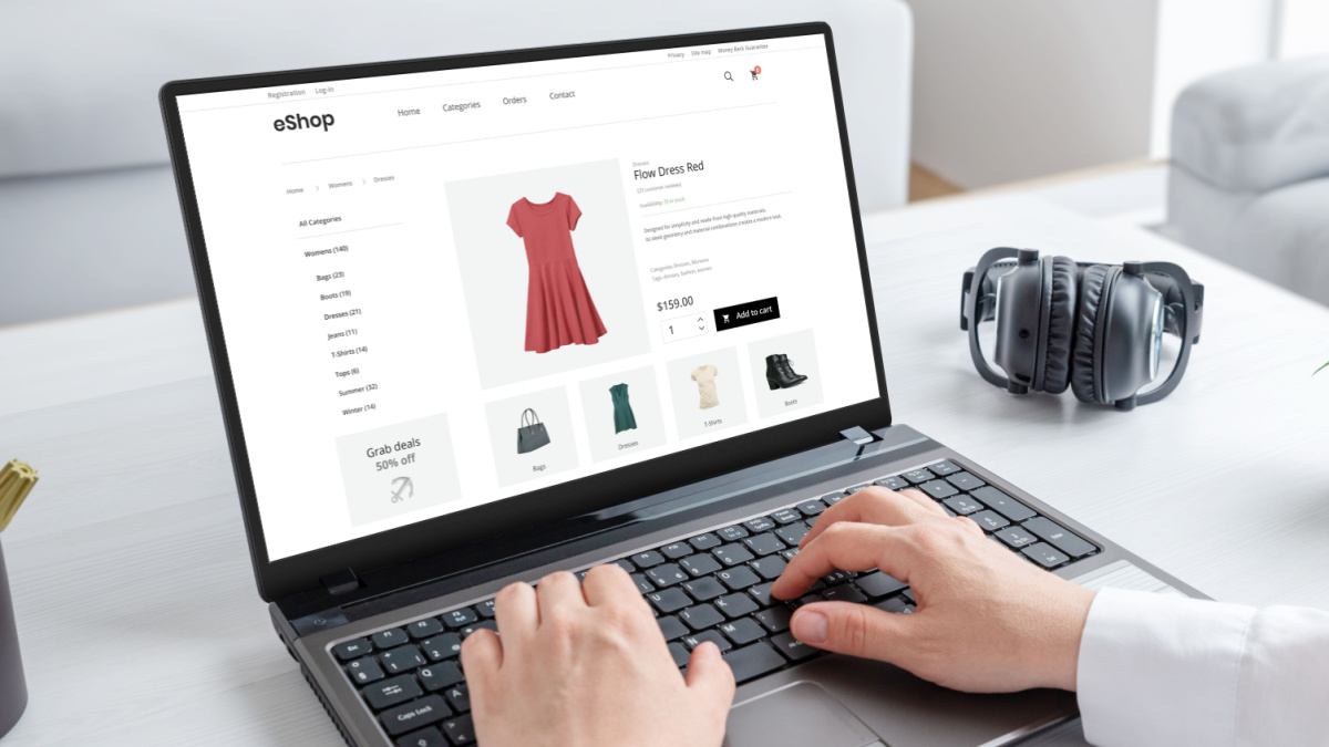 Woman purchasing a stunning red dress online with laptop computer. Modern ecommerce web page interface.