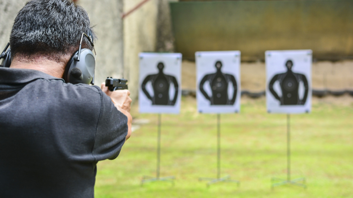 the man shooting with gun.