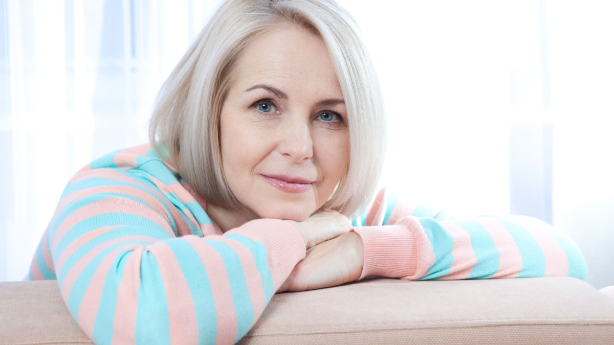 Attractive middle aged woman relaxing at home.