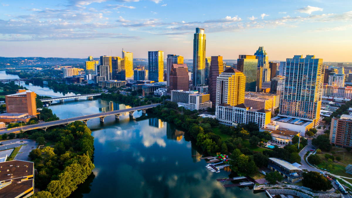 Austin Texas USA sunrise skyline cityscape over Town Lake or Lady Bird Lake with amazing reflection. Skyscrapers and Texas capital building in distance you can see the entire city during summer.