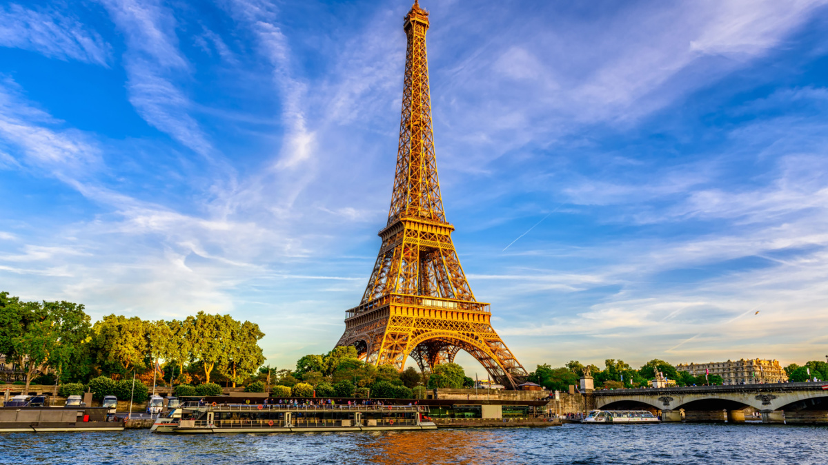 Paris Eiffel Tower and river Seine at sunset in Paris, France. Eiffel Tower is one of the most iconic landmarks of Paris.