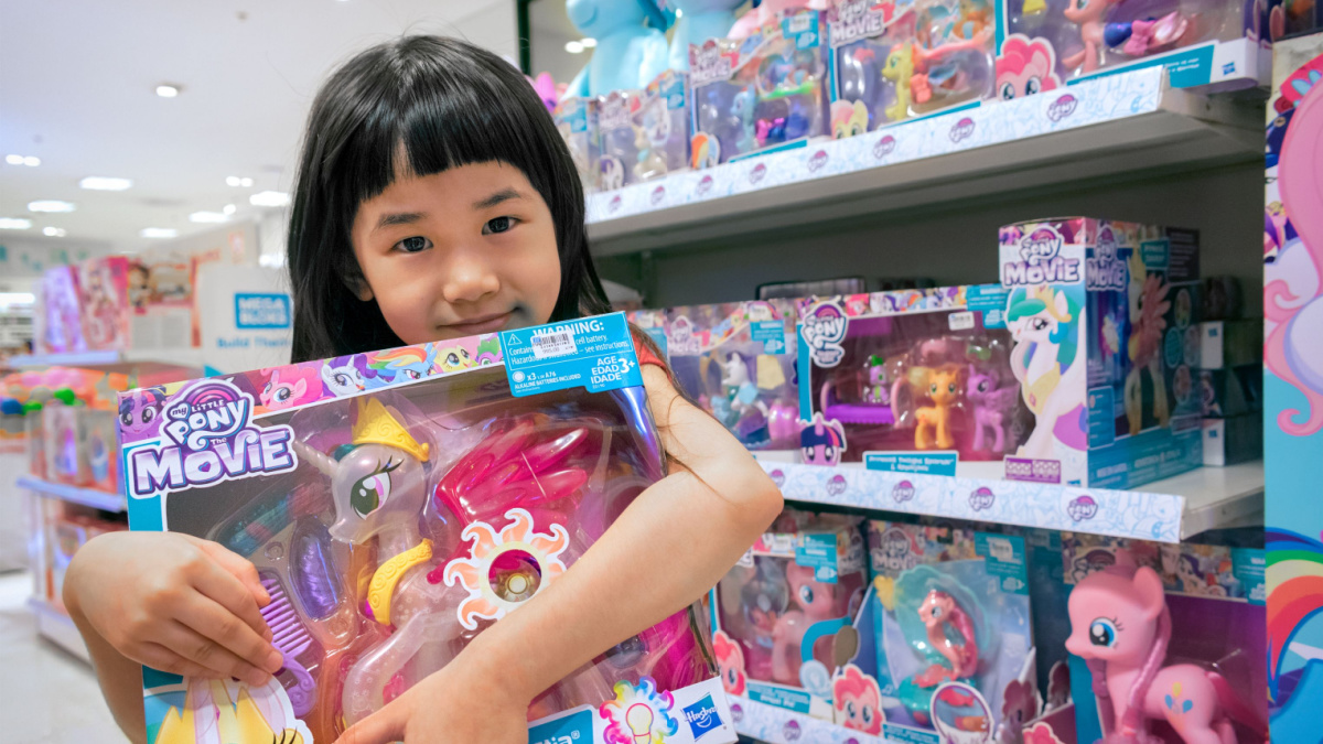 little girl shows her new My Little Pony Toy in the toy department of The Mall Bangkhae in Bangkok