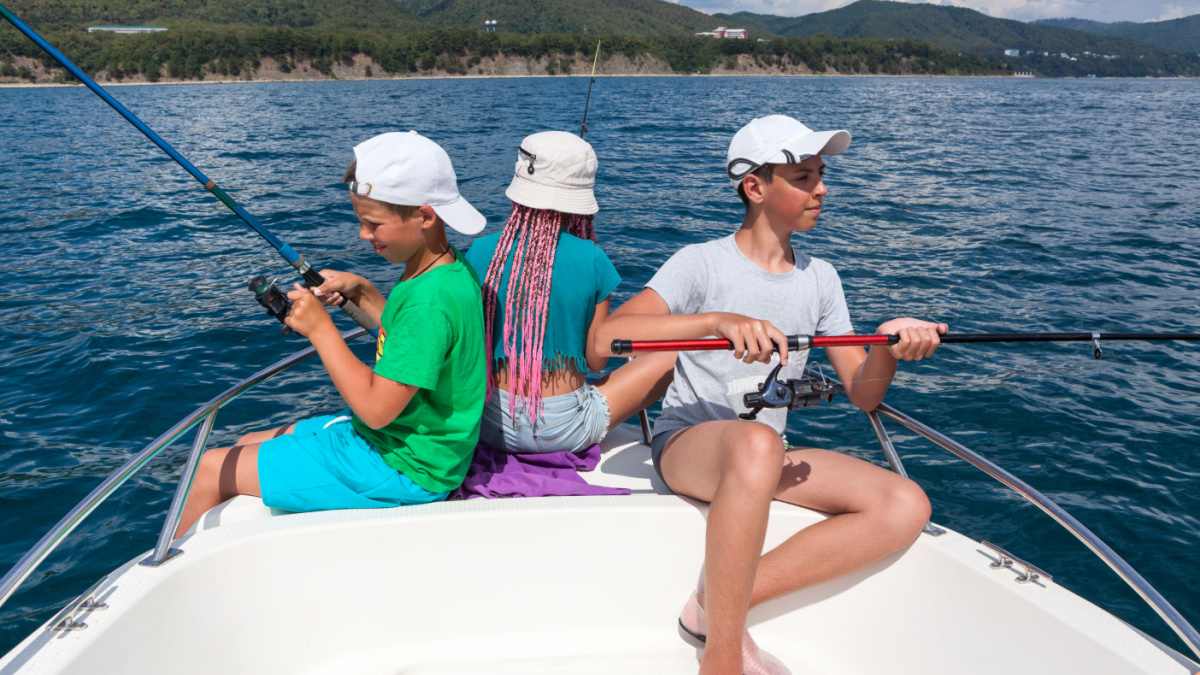 Two boys and one girl have fishing on a sailboat, deep-sea fishing trip