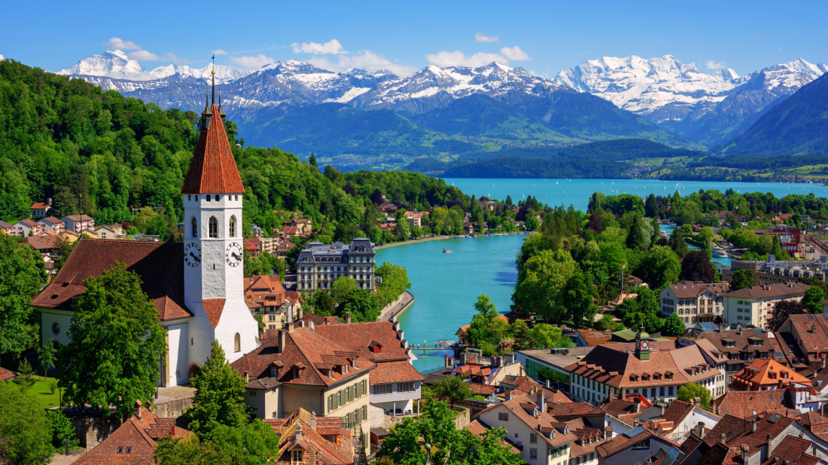 Historical Thun city and lake Thun with snow covered Bernese Highlands swiss Alps mountains in background, Canton Bern, Switzerland