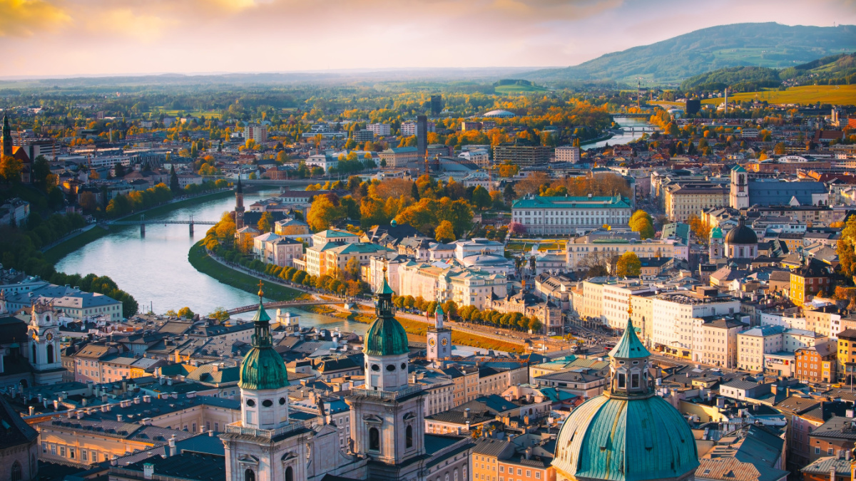 Beautiful of Aerial panoramic view in a Autumn season at a historic city of Salzburg with Salzach river in beautiful golden evening light sky and colorful of autumn at sunset, Salzburger Land, Austria