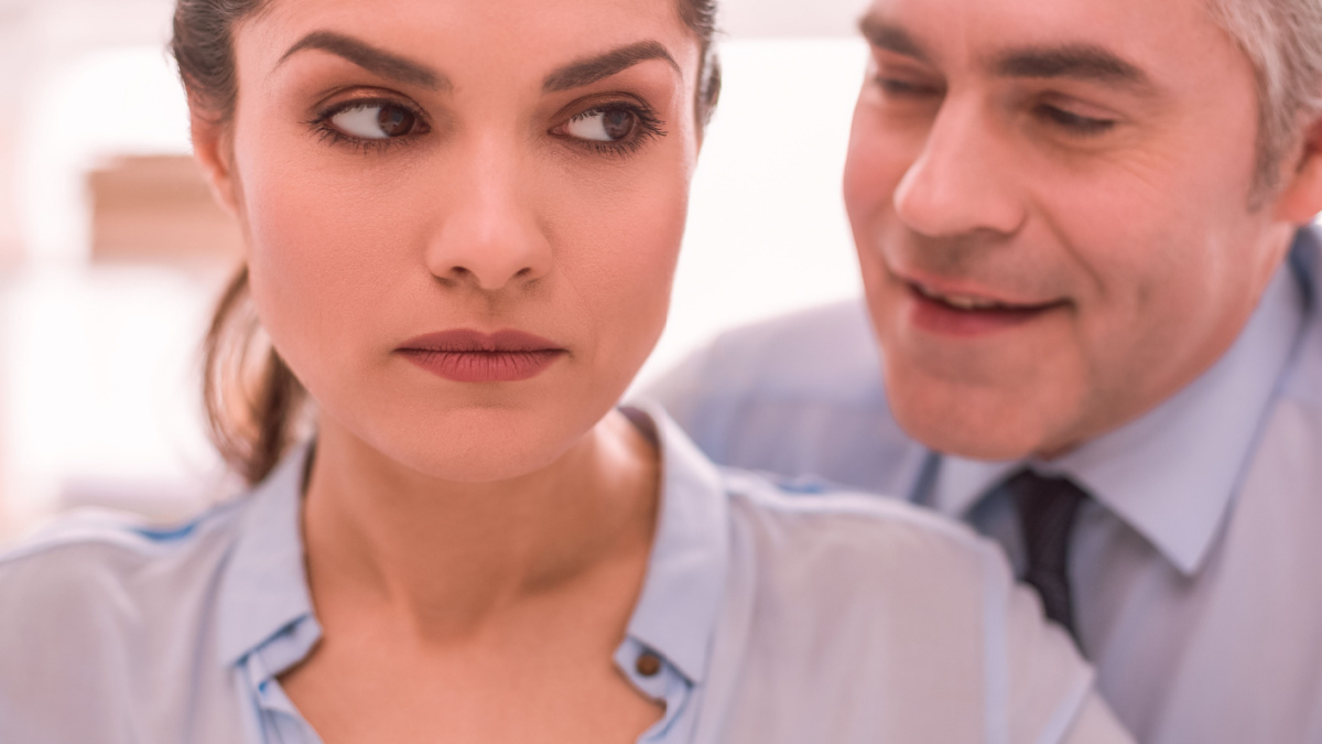 Sexism. The woman feels discriminated by her male colleague.