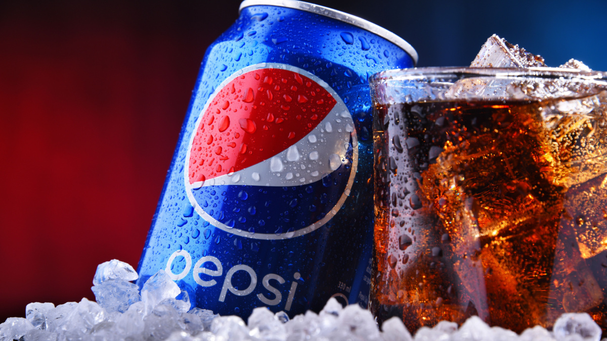 A can and a glass of Pepsi, a carbonated soft drink produced and manufactured by PepsiCo. The beverage was created and developed in 1893 under the name Brad's Drink