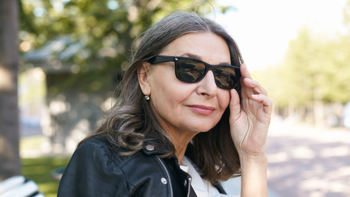 Close up summertime picture of trendy looking stylish 50 year old European female fashion blogger.