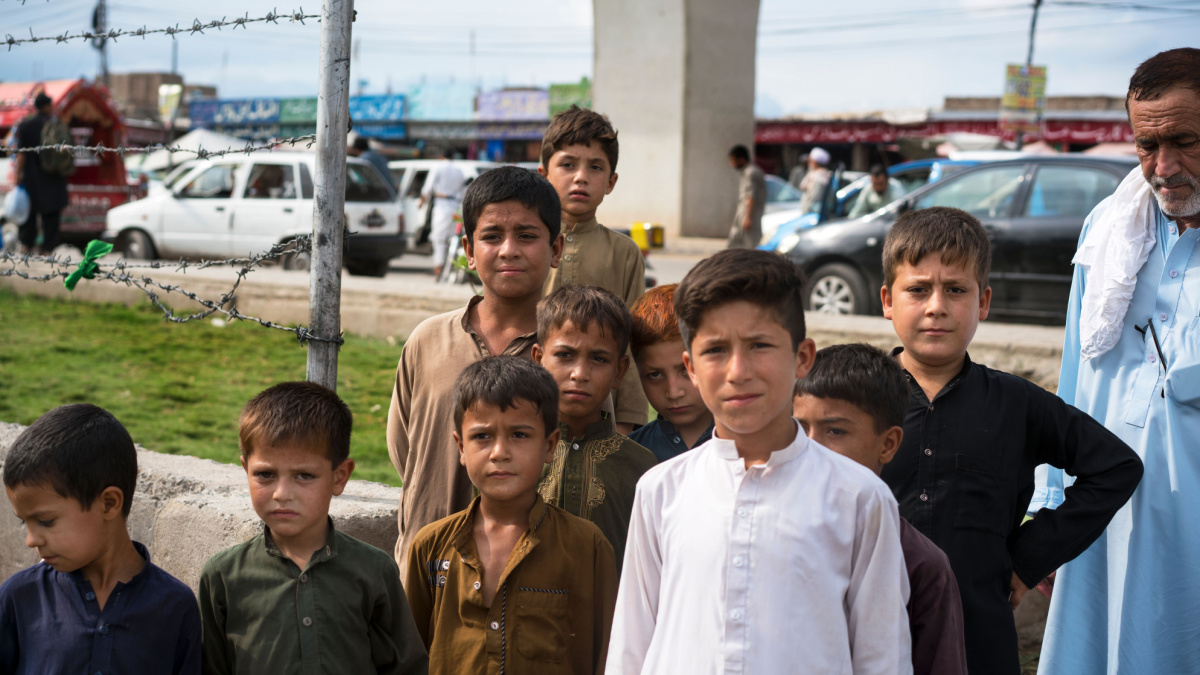 Afgan refugee boys are posing during the sacrifice feast at Karkhanai Bazaar, Peshawar, Pakistan