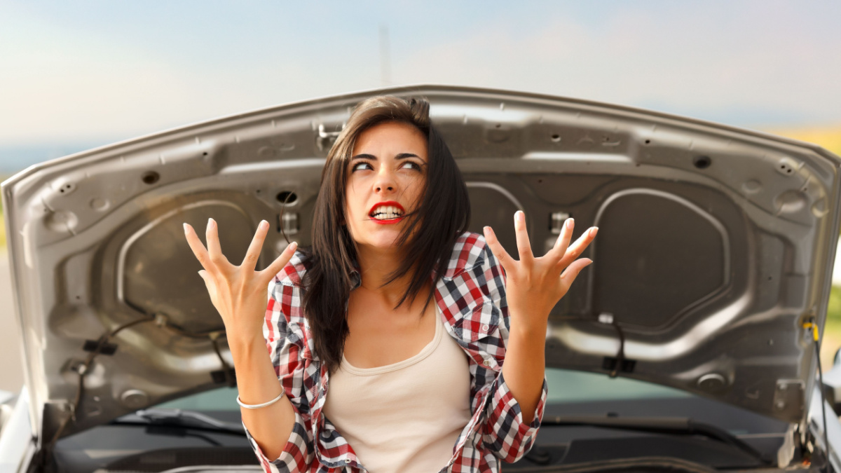 Woman being very angry because of her car's failed engine.