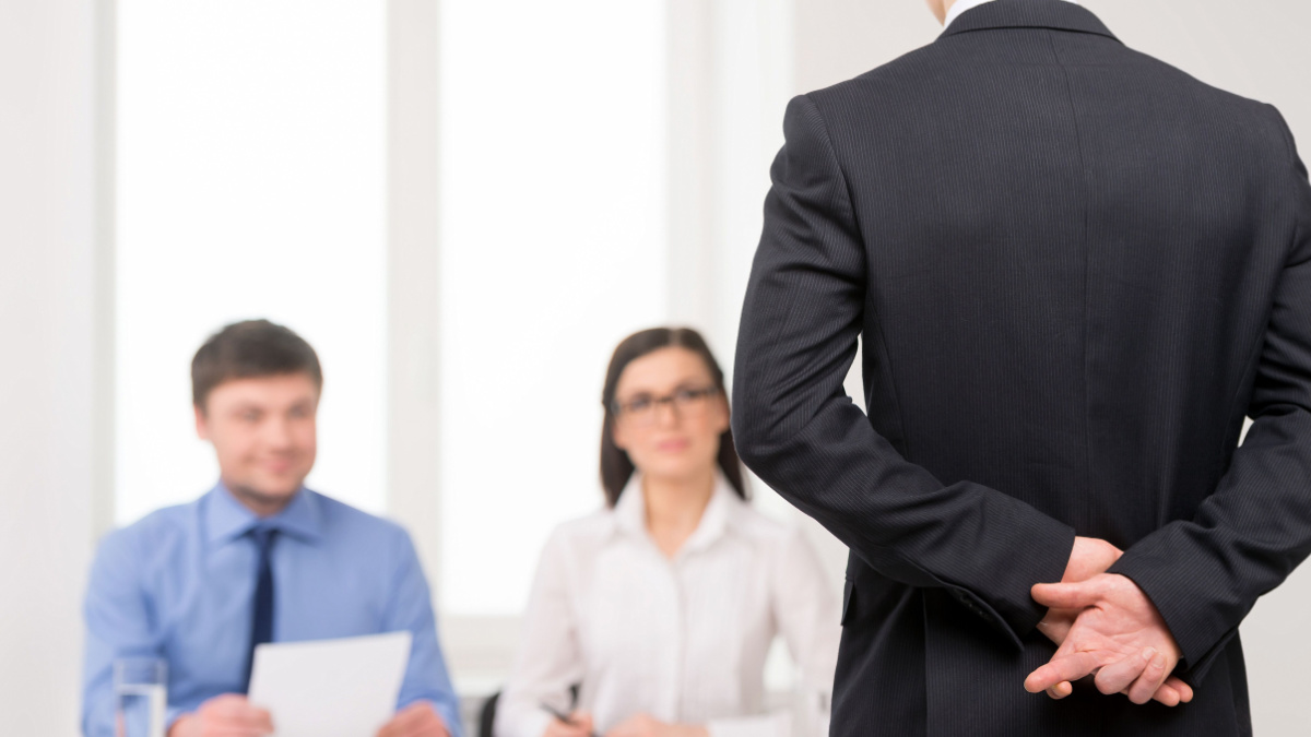 Close up of man back with fingers crossed behind. Idea of lying on job interview