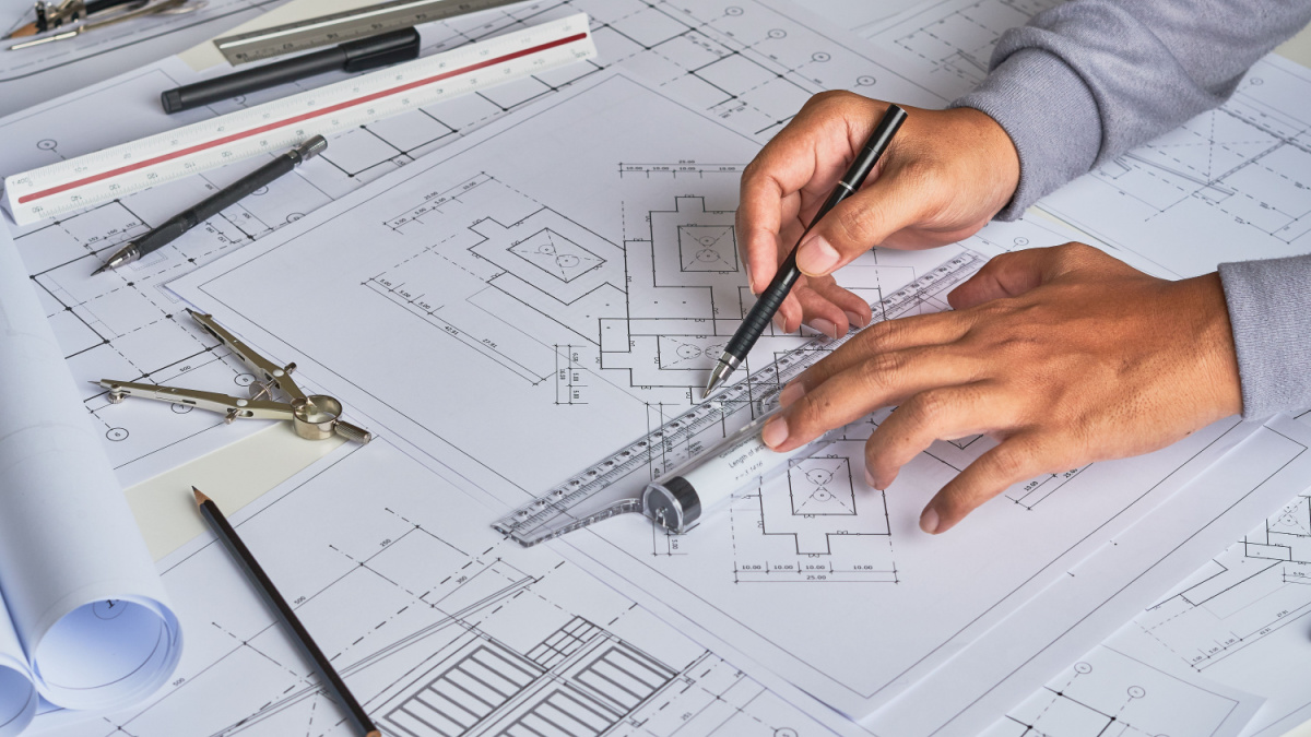 Architect engineer contractor design working drawing sketch plan blueprint and making architectural construction house building in architect studio.