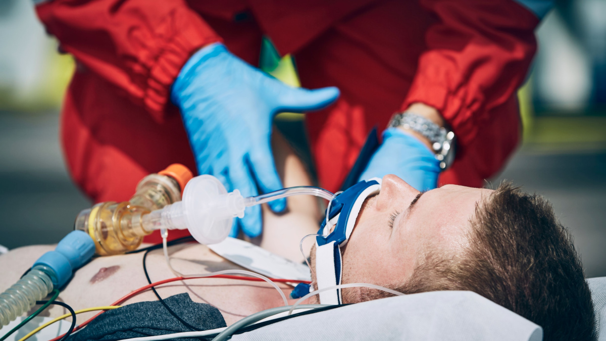 Paramedic of emergency medical service helping man after cardiopulmonary resuscitation. Themes help, hope a health care.
