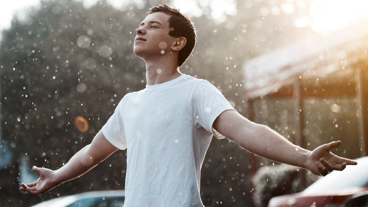 teenage boy under rain in the city.