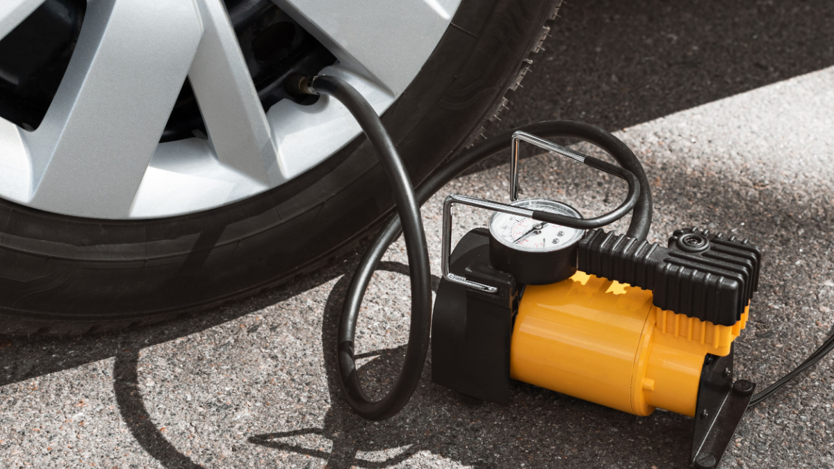 Automobile compressor. Electric pump inflates a car wheel close-up