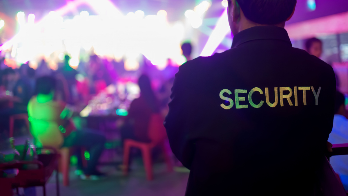 Security guard bouncer are regulating the situation of safety in an event concert in a nightclub.