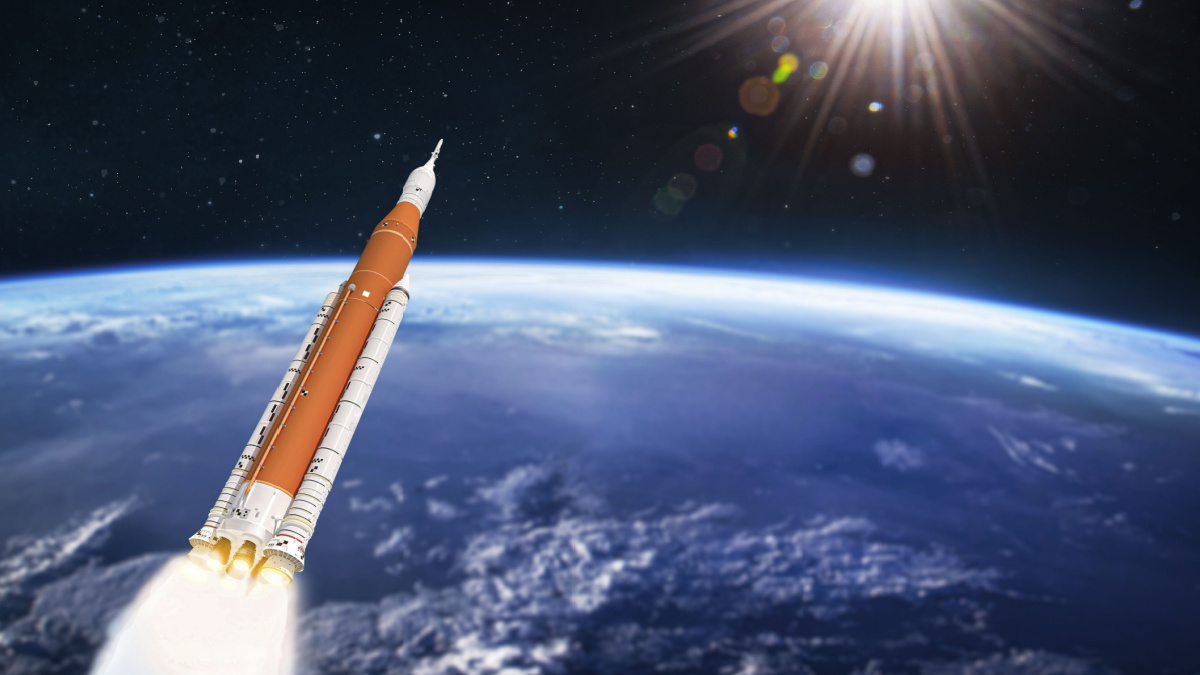 Space launch system rocket in outer space over Earth planet. SLS spaceship. Orbit of planet. Deep space expedition. Elements of this image furnished by NASA.