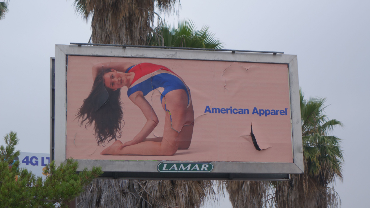 Los Angeles, California, USA - May 28 2014: A Los Angeles street corner with a ubiquitous American Apparel billboard featuring a scantily clad woman.