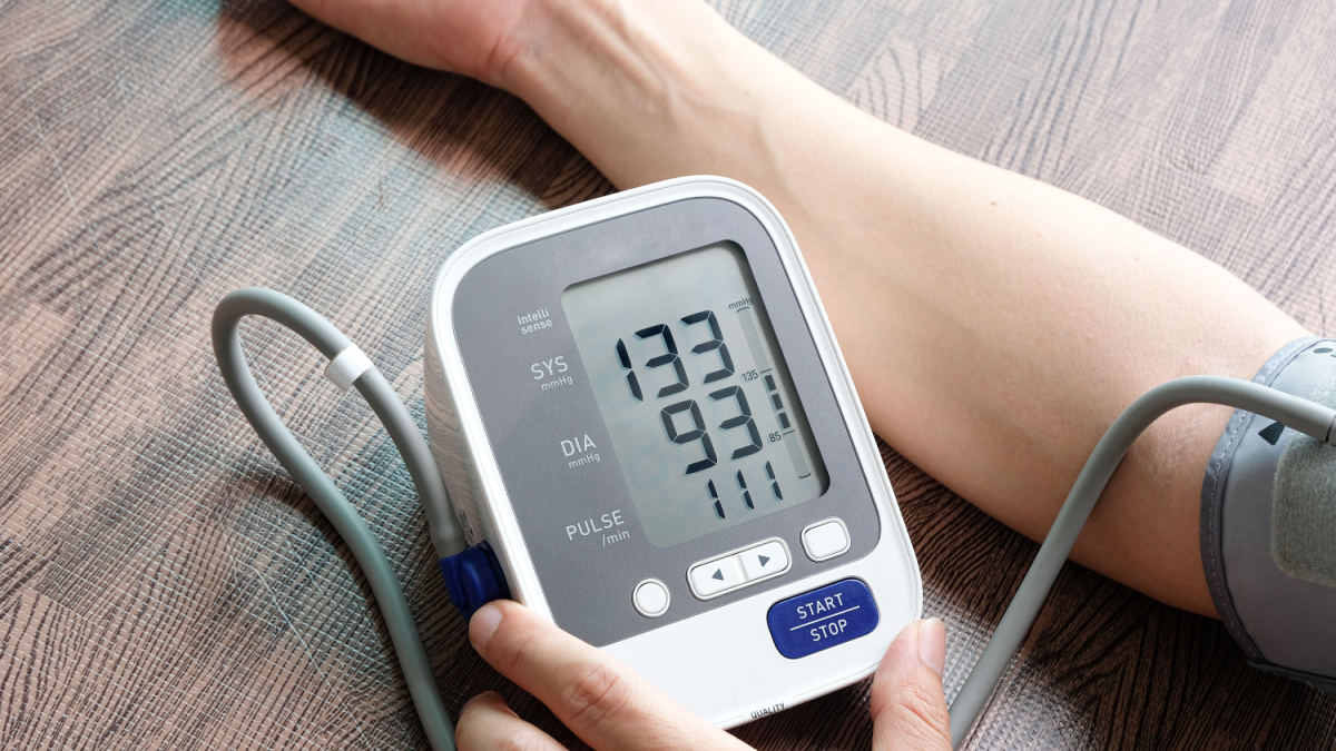Man check blood pressure monitor and heart rate monitor with digital pressure gauge.