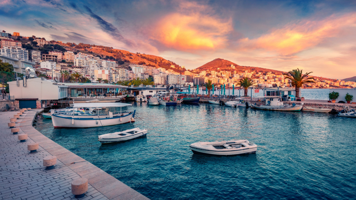 Fantastic spring cityscape of Saranda port. Captivating Ioninian seascape. Wonderful evening scene of Albania, Europe. Traveling concept background.