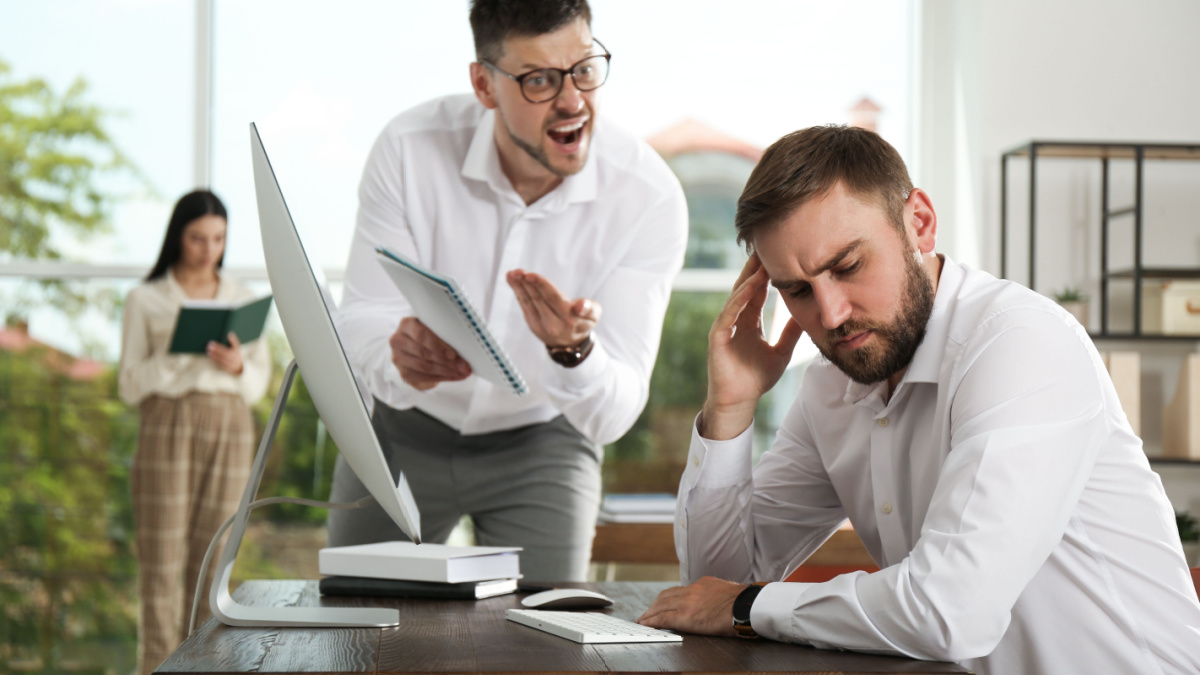 Boss screaming at employee in office. Toxic work environment