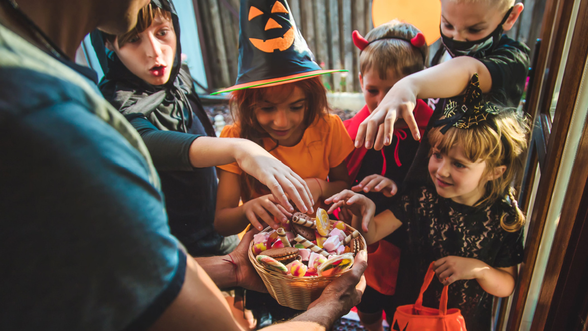 Children celebrate Halloween dressed up in costumes.