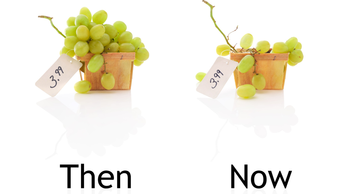 Downsized bunches of grapes for sales comparison. Inflation, skimpflation or shrinkflation concept of less for the same price.