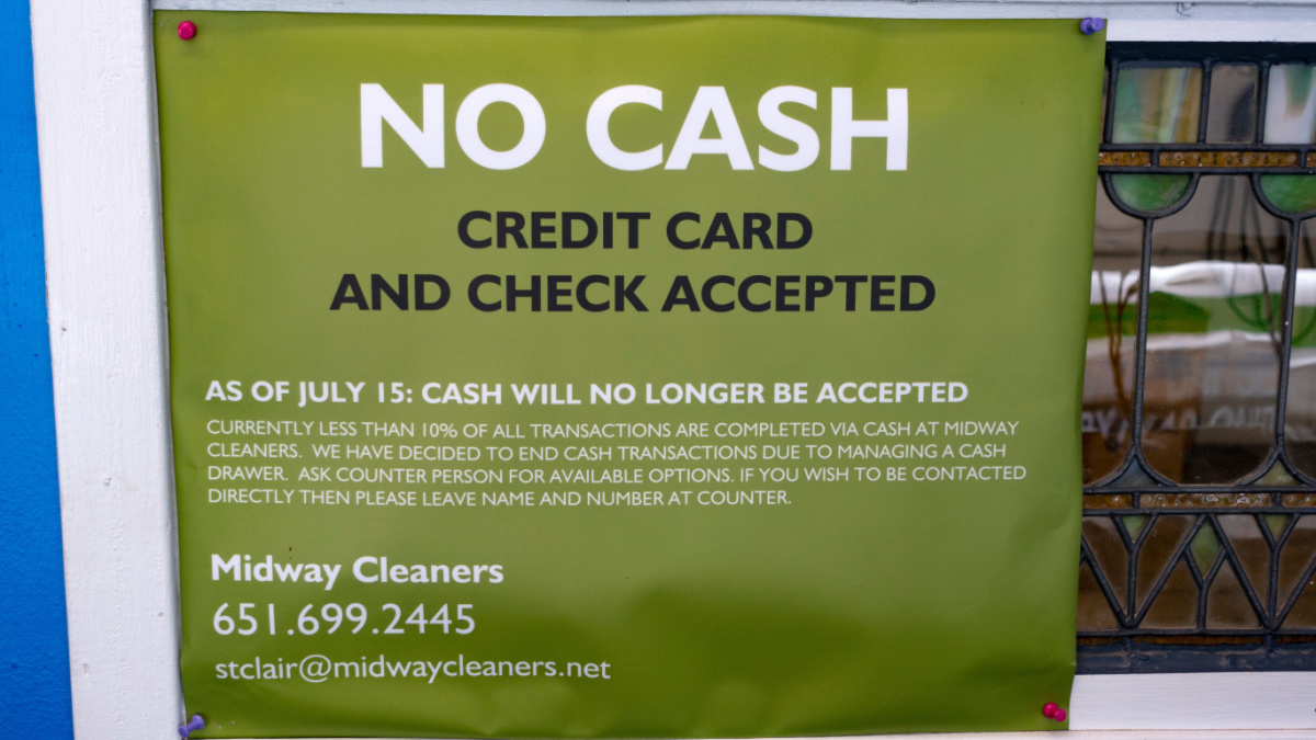Sign for Midway Cleaners no longer accepting cash for payment, only credit card or check.