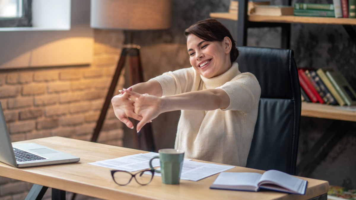 woman cracking her knuckles at the desk