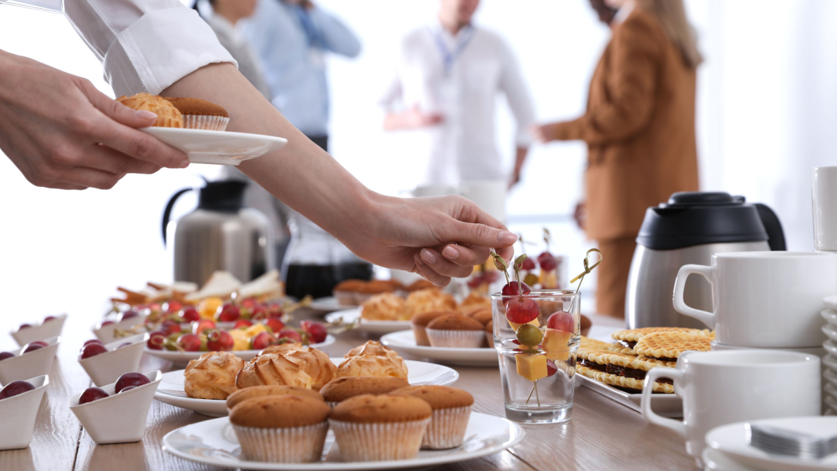 Woman taking snack during coffee break, closeup