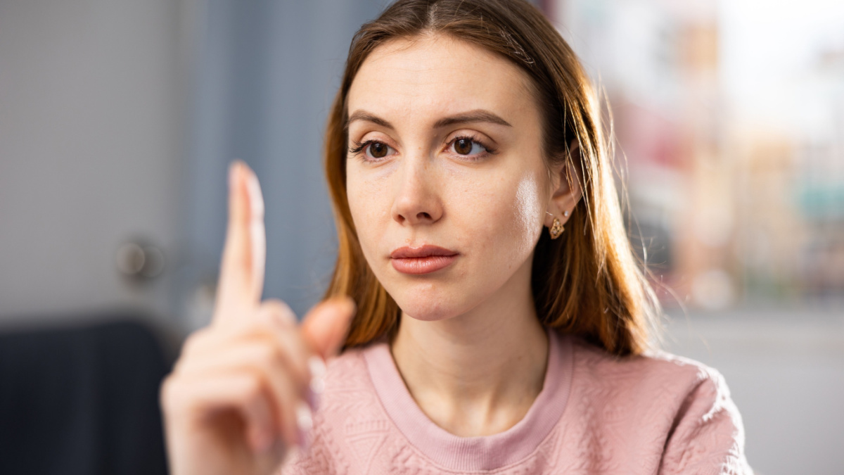 Portrait of a young european woman who concentrated her gaze on her index finger while performing a gymnastic exercise for ..the eyes. Close-up portrait
