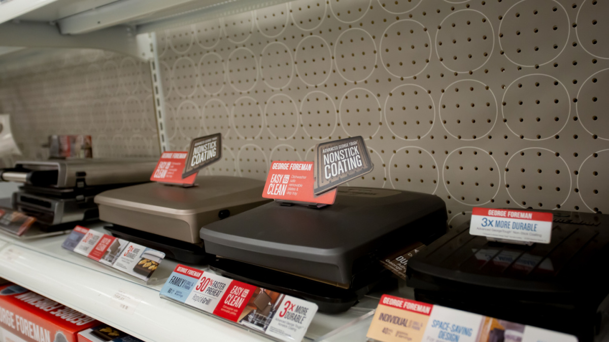 A view of a shelf dedicated to a variety of George Foreman grill appliances, on display at a local department store.