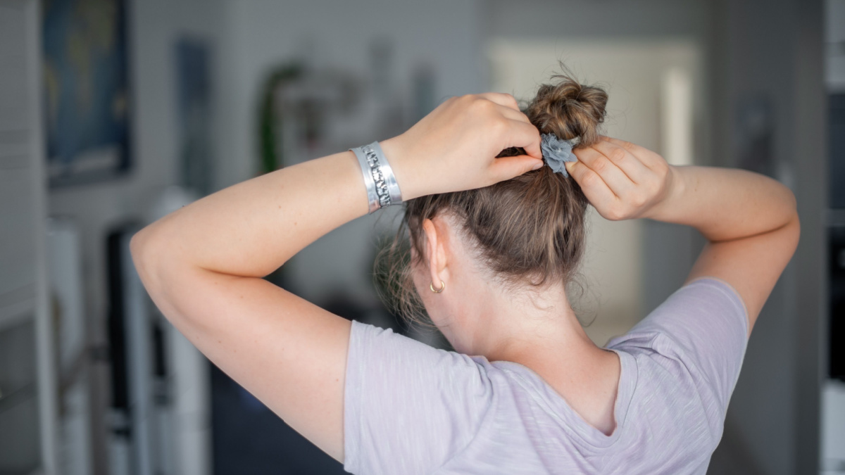 young woman tying her hair