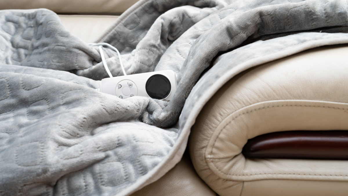 electric blanket with controller on a sofa