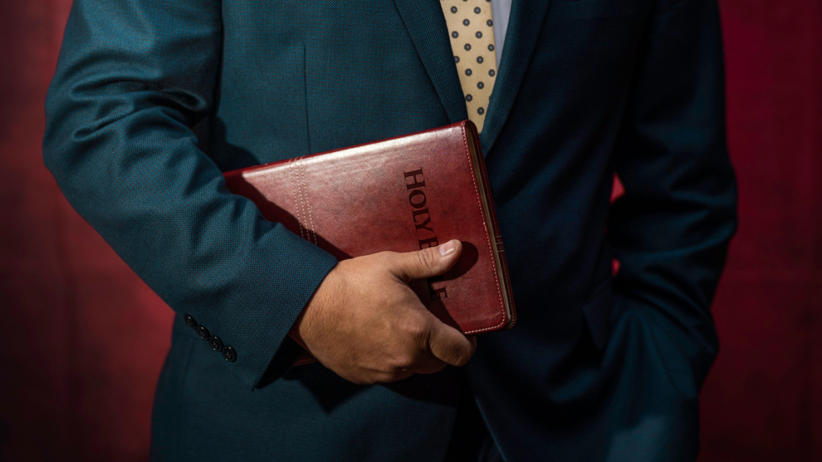 Evangelical Pastor Holding The Holy Bible. Church Concept.