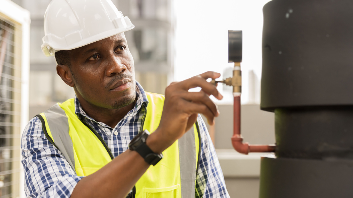 Close up of male plumber engineer or technician worker working in sewer pipes area at construction site.