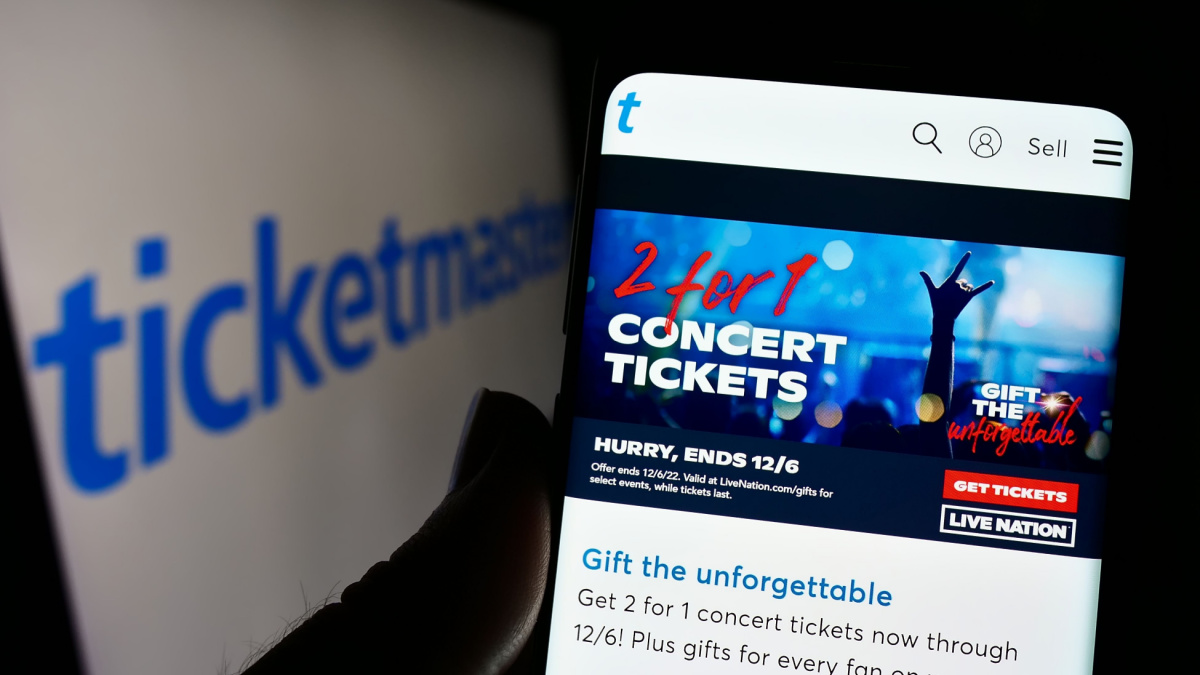 Stuttgart, Germany - 12-02-2022: Person holding smartphone with webpage of US company Ticketmaster Entertainment Inc. on screen in front of logo.