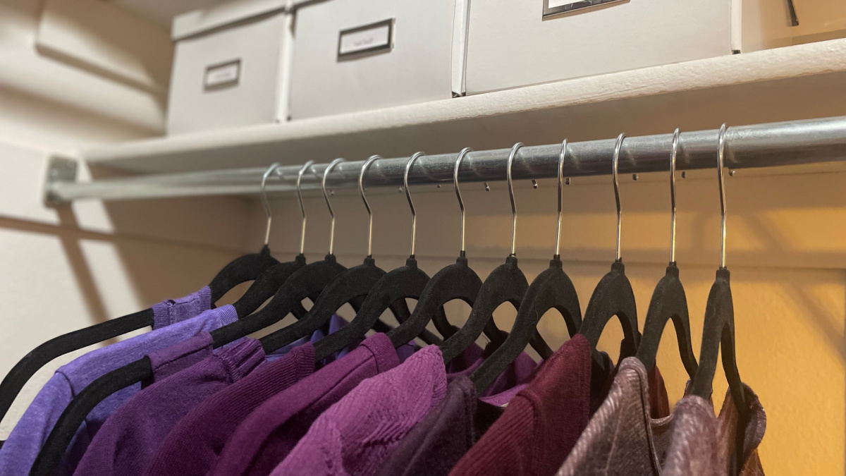 Organized home closet with velvet hangers and storage bins
