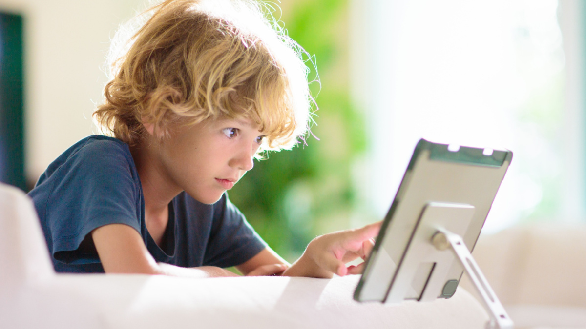 Kids with tablet computer. Child with pc watching movie or playing game. Educational online program for school child. Boy with digital device and gadget. Screen time and education for young kid.